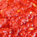 Freshly prepared red stew served as a meal accompaniment.